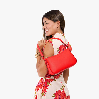 Candy*Small | Model carrying petite bean shaped shoulder bag with a zipper closure