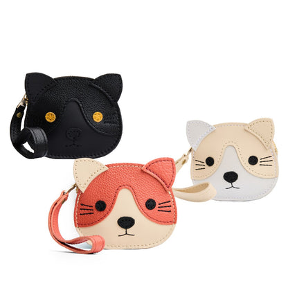 All Variants | Three small cat-shaped leather pouches with embroidered facial details and a wrist strap.