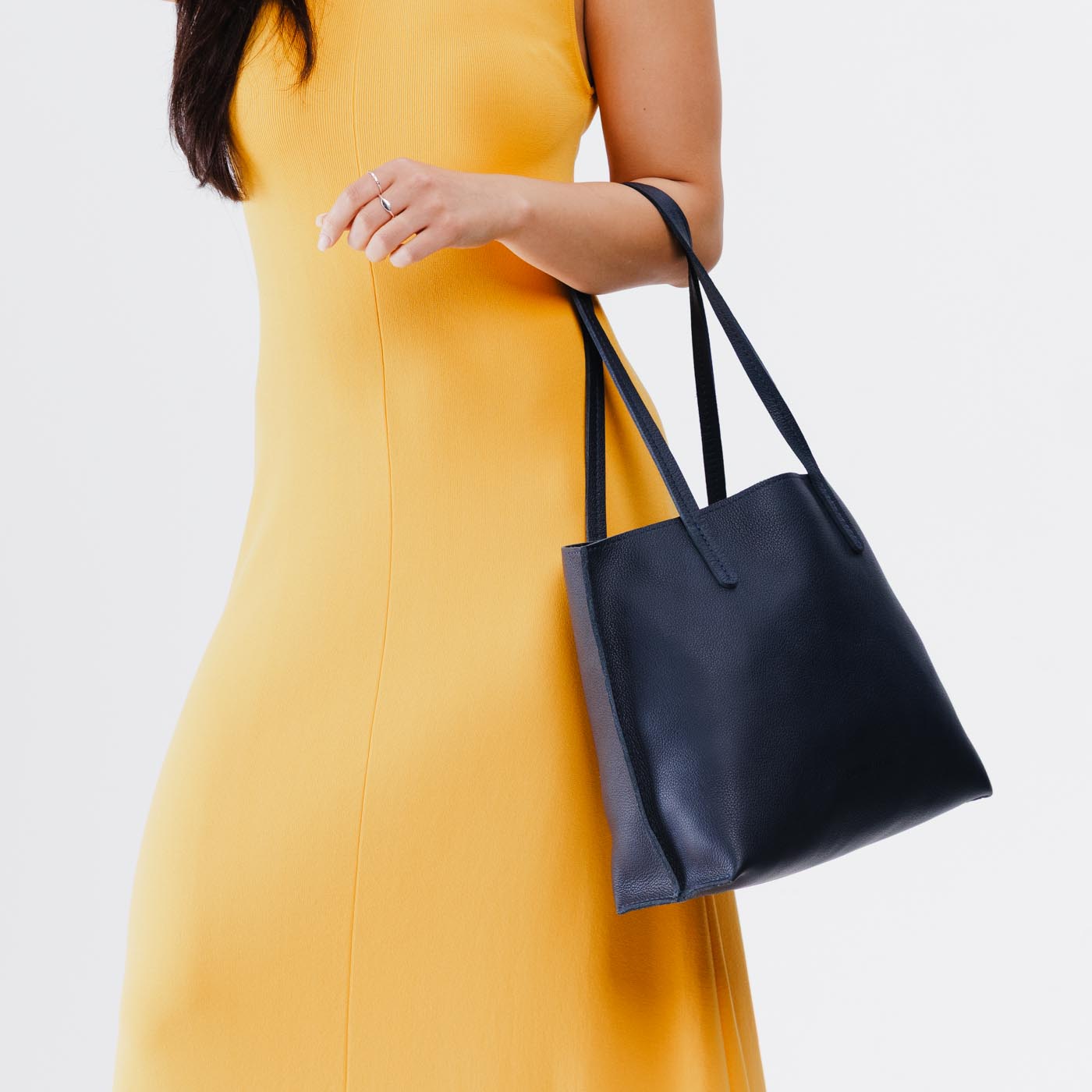 Night Owl*Medium | Model holding leather tote bag with interior snap key loop