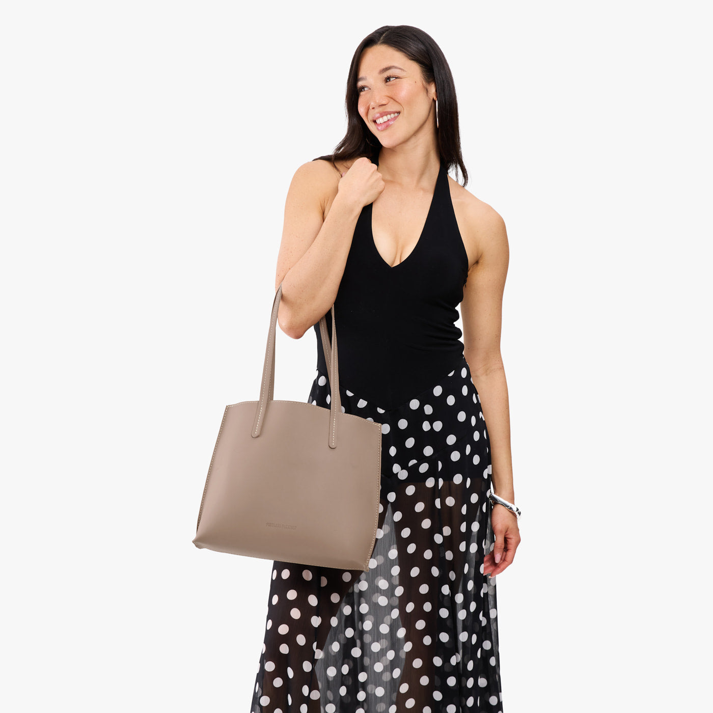 Stone*Medium | Model carrying leather tote bag with matching leather handles