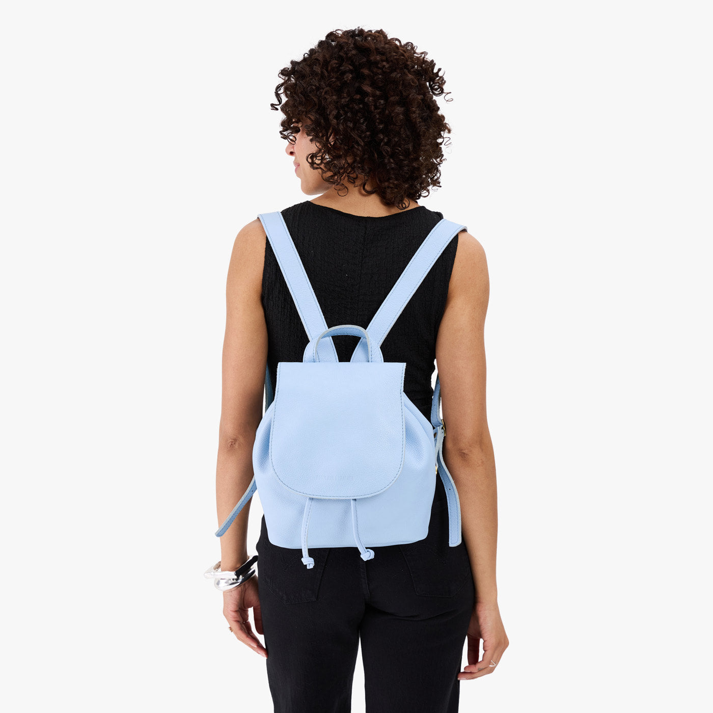Skyway | Pebbled leather drawstring backpack being worn by a person