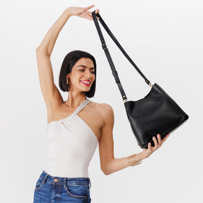 Black | symmetrical bucket bag with latch closure and removable crossbody strap