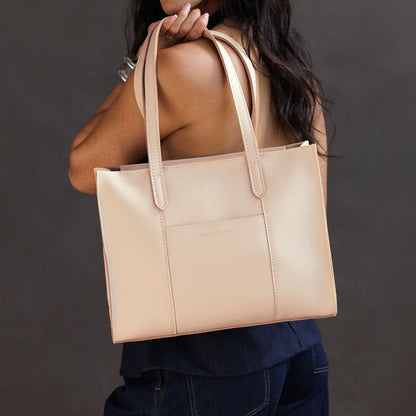 Moonflower*East/West | Model wearing structured wide tote bag with overlapping panels and crossbody strap