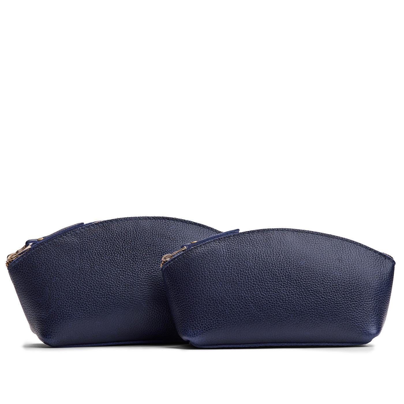Cobalt | Comparison of two sizes of spacious leather makeup bags with curved seams and top zipper