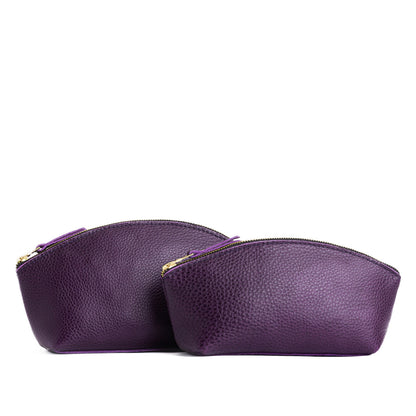 Empire | Size comparison shot of two spacious leather makeup bags with curved seams and top zipper
