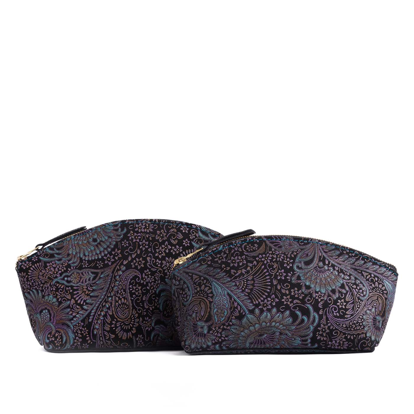 Masquerade | Size comparison shot of two spacious leather makeup bags with curved seams and top zipper