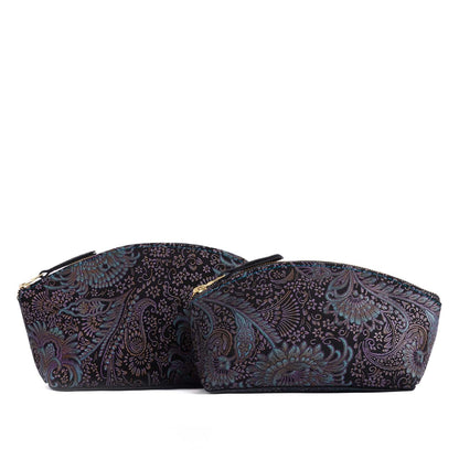 Masquerade | Size comparison shot of two spacious leather makeup bags with curved seams and top zipper