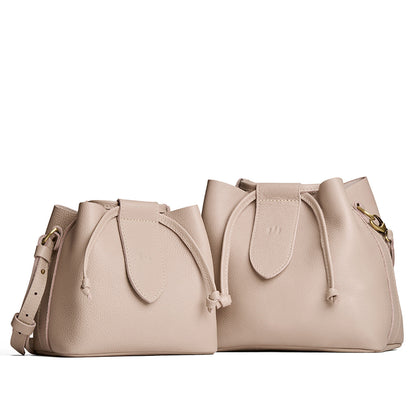 Oatmilk | Small and large symmetrical leather bags with leather drawstring closure and adjustable shoulder strap