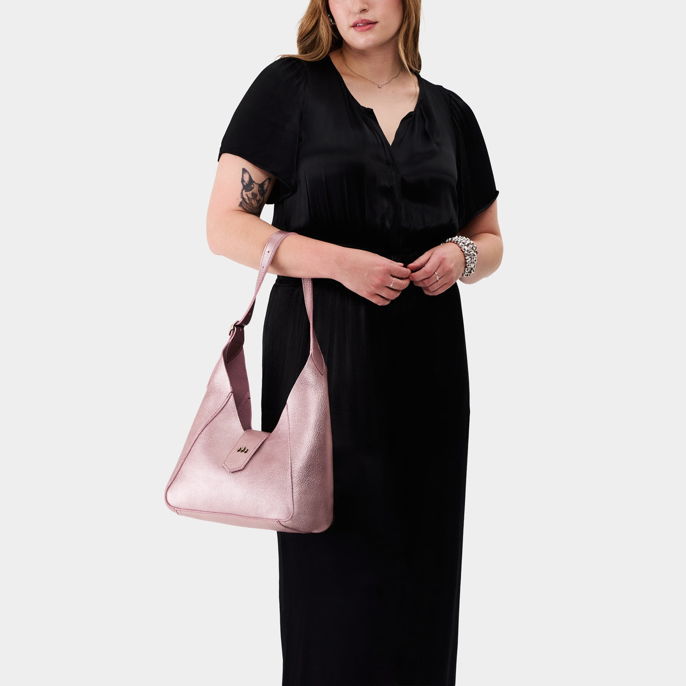 Supernova | Model wearing structured hobo shoulder bag with adjustable strap and magnetic closure