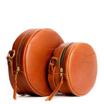 Honey | Size comparison image of small and large circle shaped crossbody bags with top zipper
