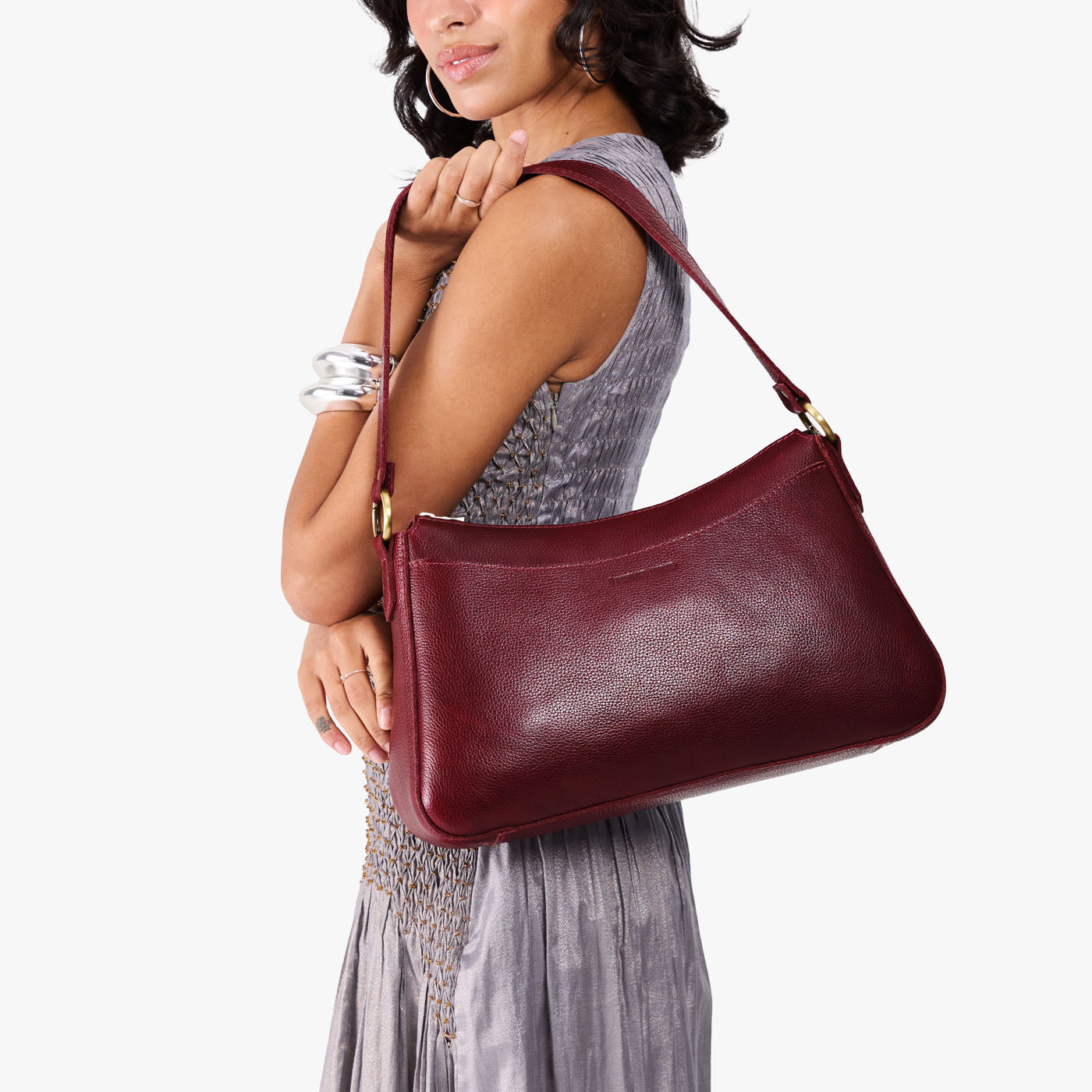 Cabernet*Large | Model holding a bean shaped shoulder bag with a zipper closure