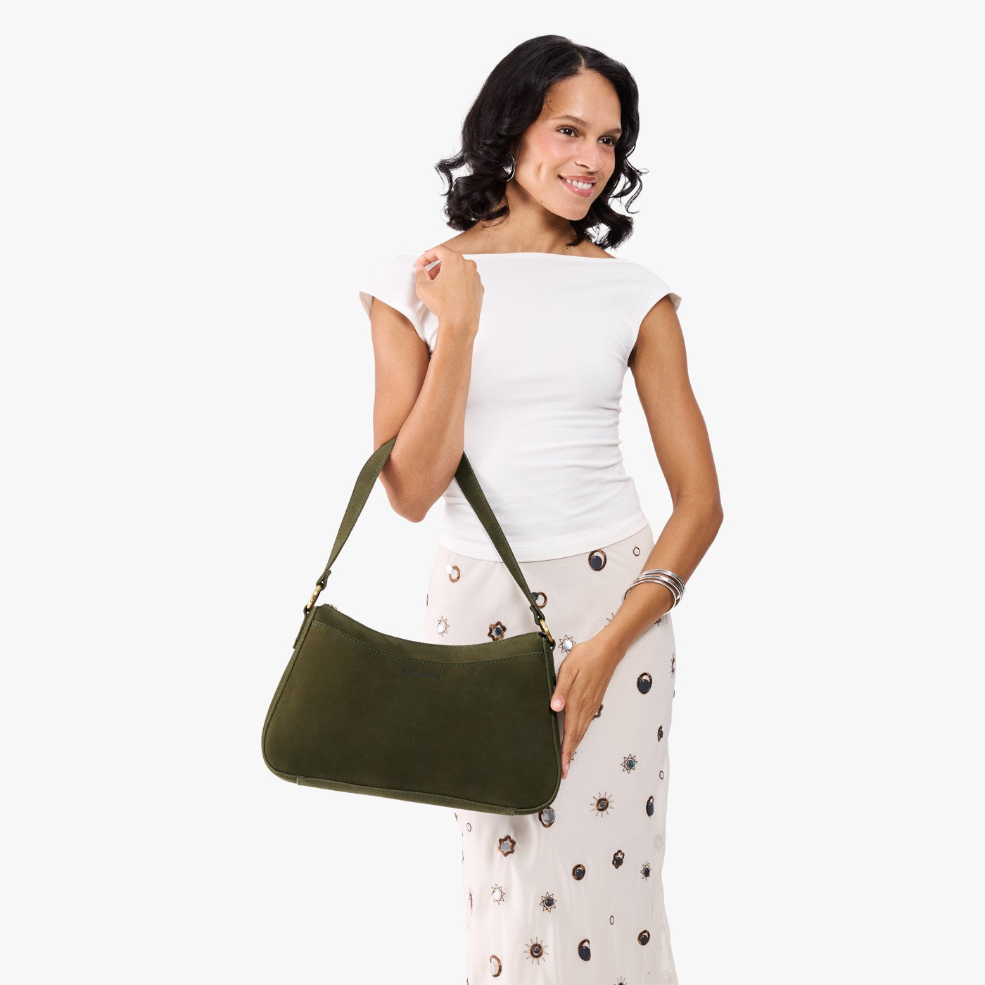 Verdant*Large | Model holding a bean shaped shoulder bag with a zipper closure