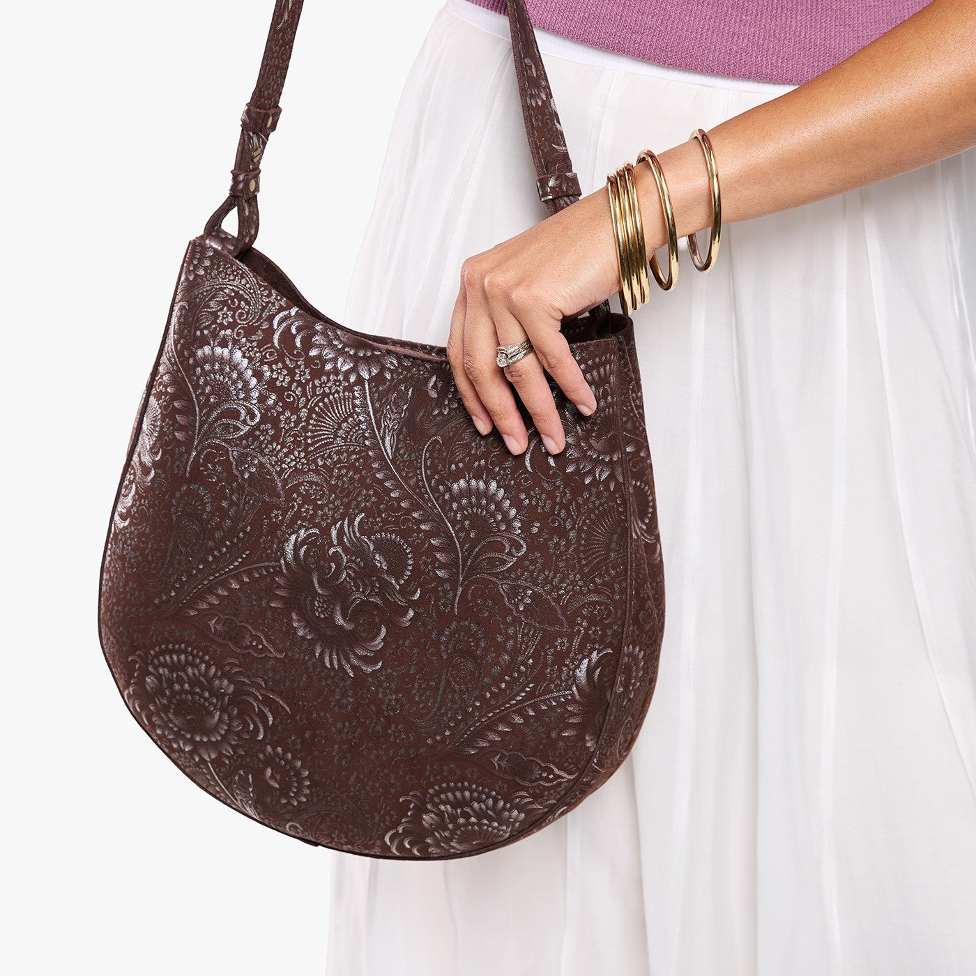 Sepia*Large | Model holding round leather purse with adjustable shoulder strap