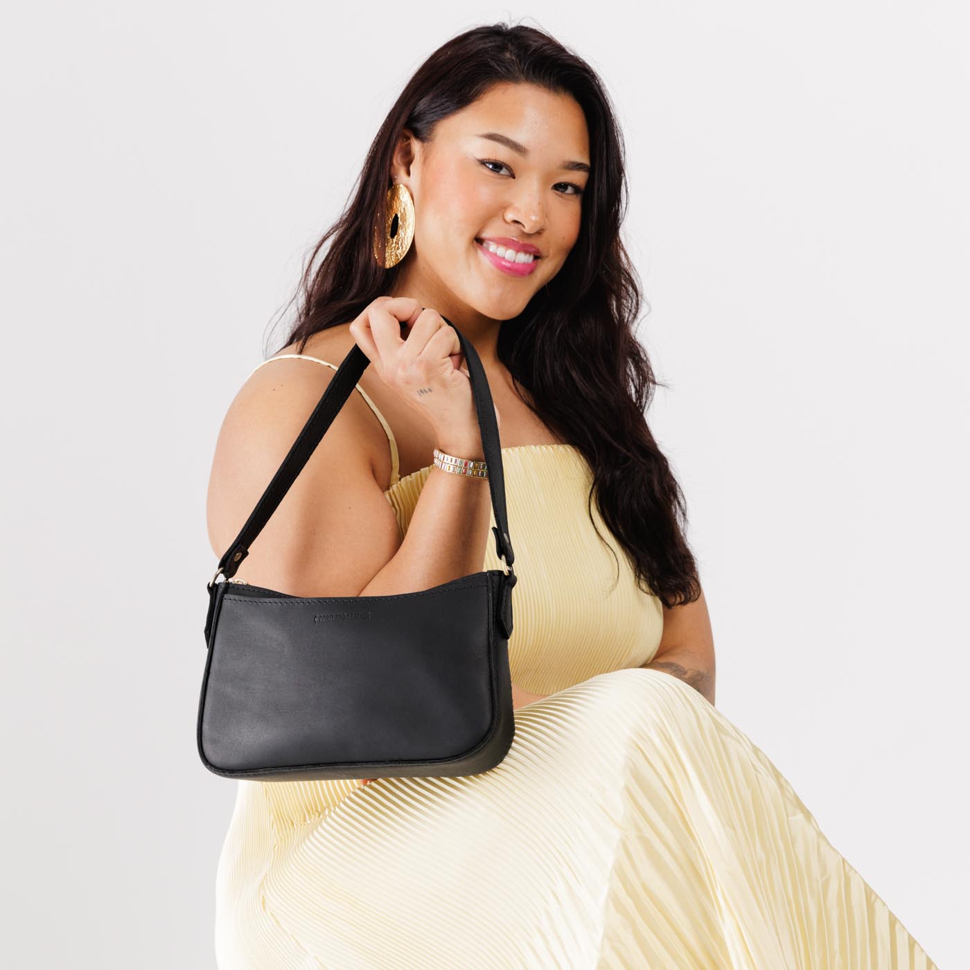 Black*Small | Petite bean shaped shoulder bag with a zipper closure