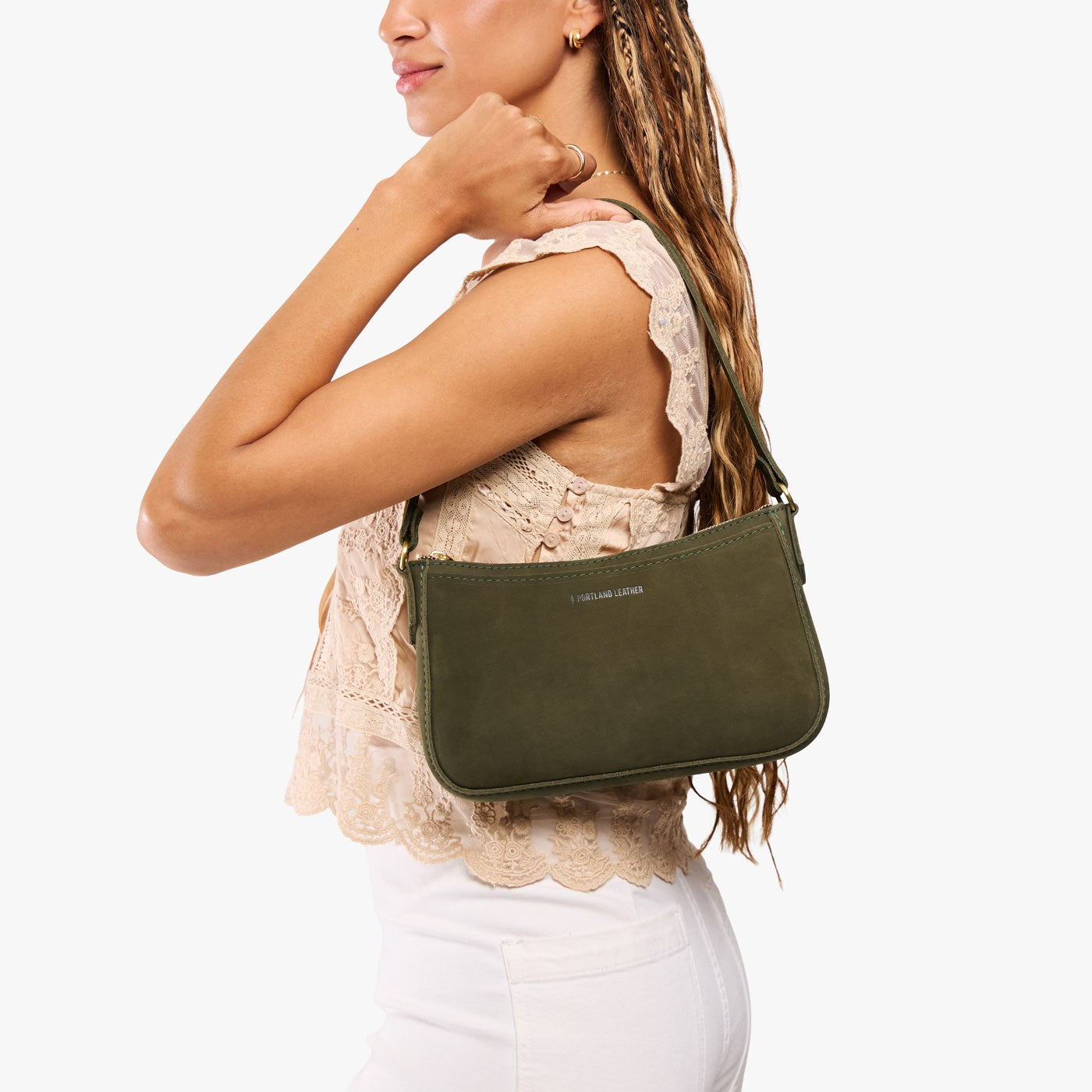 Verdant*Small | Model carrying petite bean shaped shoulder bag with a zipper closure