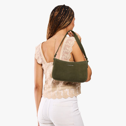 Verdant*Small | Model carrying petite bean shaped shoulder bag with a zipper closure