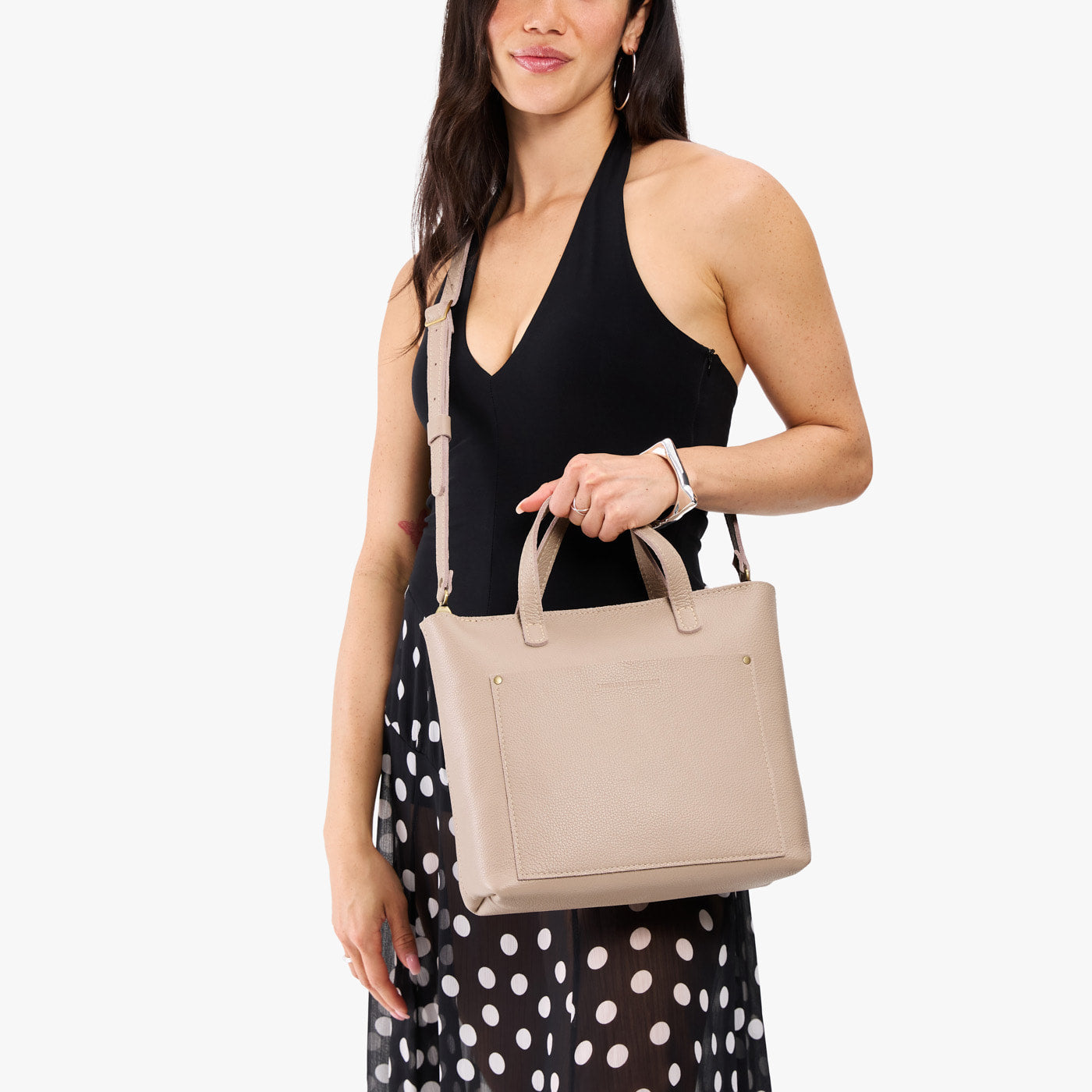 Oatmilk*Zipper | Model holding midsize crossbody tote with handles, zipper top, and a pocket