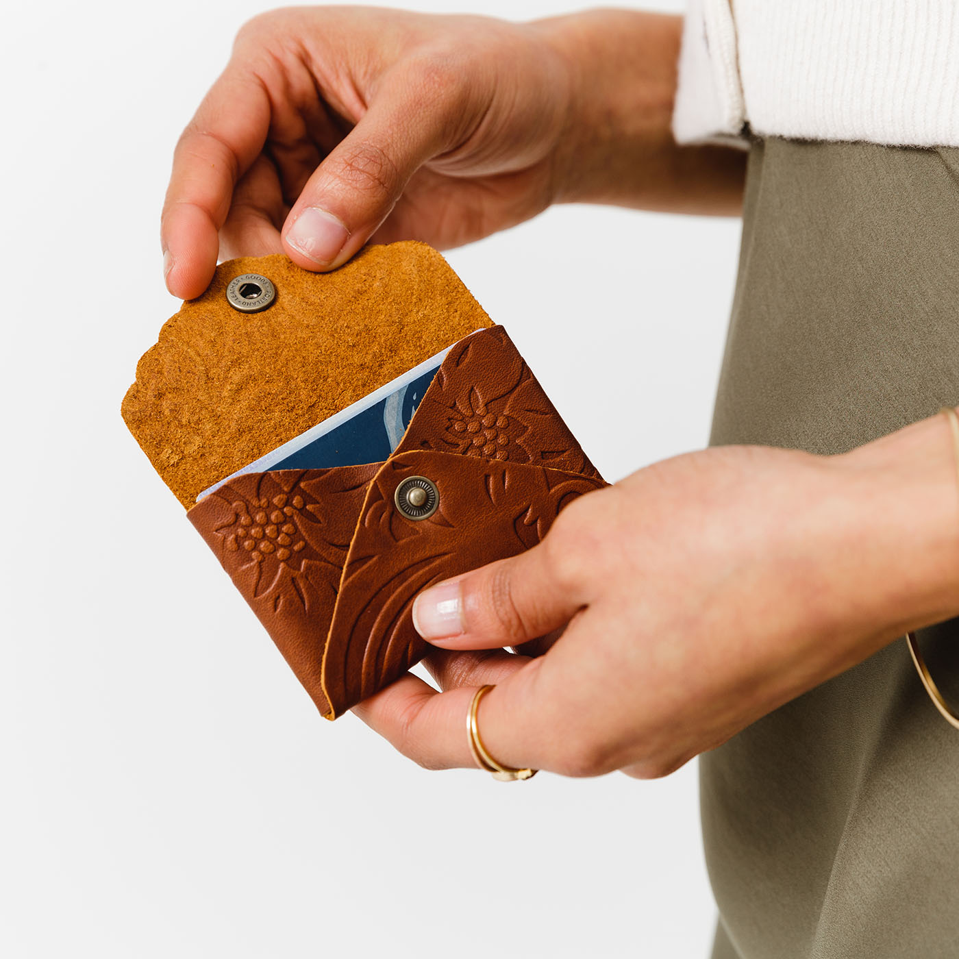 Meadow | Model holding small leather wallet with scalloped edge open