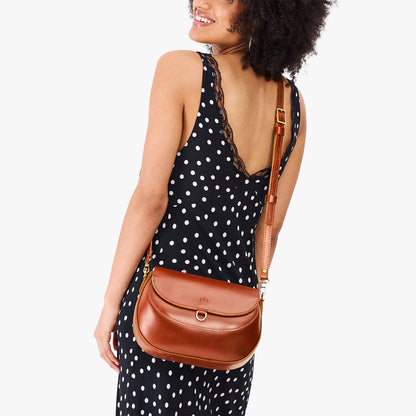 Madrone*Large | Model wearing a leather Crossbody with a flap and magnetic closure