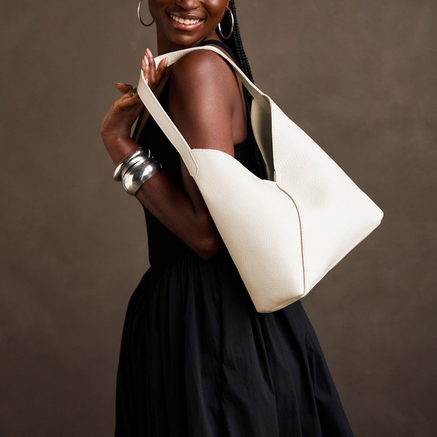 Pebbled Bone*Large | Model carrying mid-size shoulder bag with magnetic snap closure