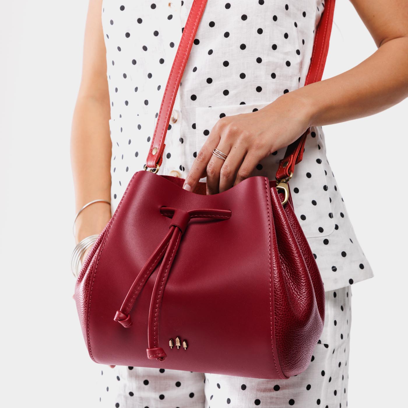 Chili Red | Model wearing bucket bag with cinched drawstring closure