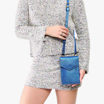 Comet Blue | Model wearing slim, phone-shaped crossbody purse with magnetic closure