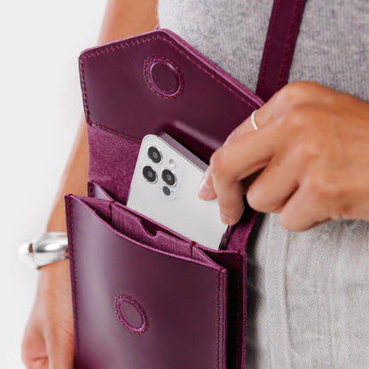 Lollipop | Model wearing slim, phone-shaped crossbody purse with magnetic closure