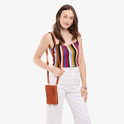 Madrone | Model wearing slim, phone-shaped crossbody purse with magnetic closure