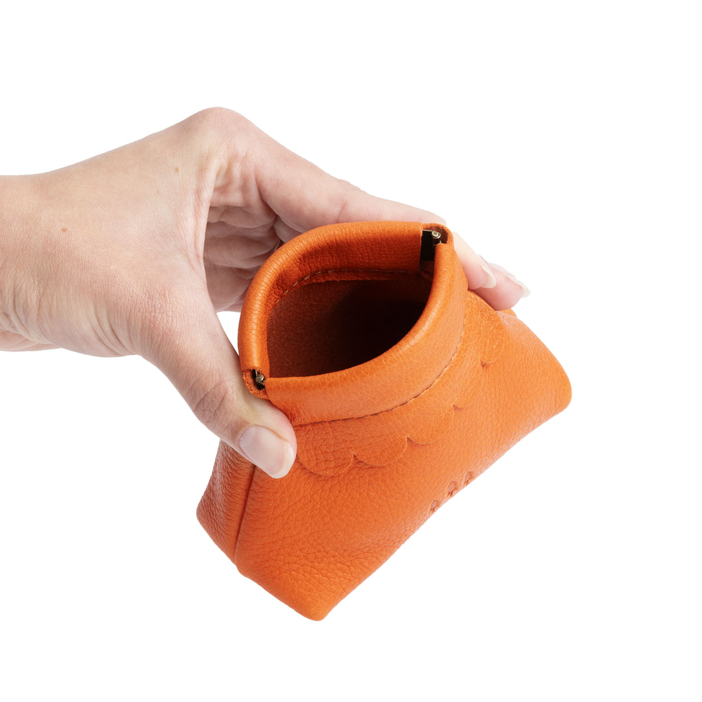 Cape Coral | Hand holding leather coin pouch with scalloped edge and three Portland leather tree emblems open
