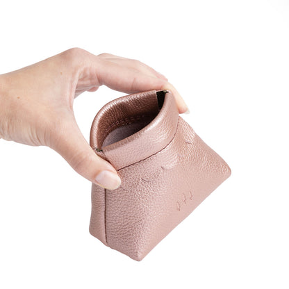 Supernova | Hand holding leather coin pouch with scalloped edge and three Portland leather tree emblems open