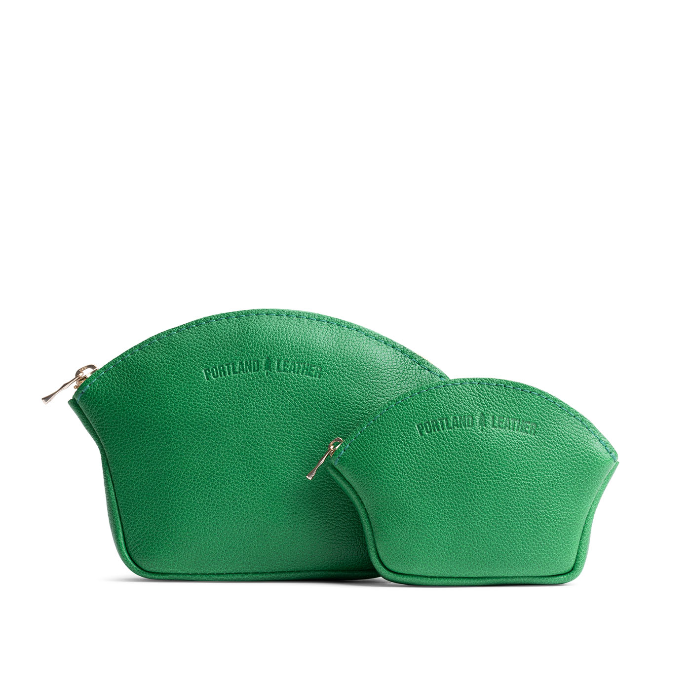 Jolly Green | Comparison shot of small and large seashell shaped leather makeup bags with curved top zipper and flat bottom