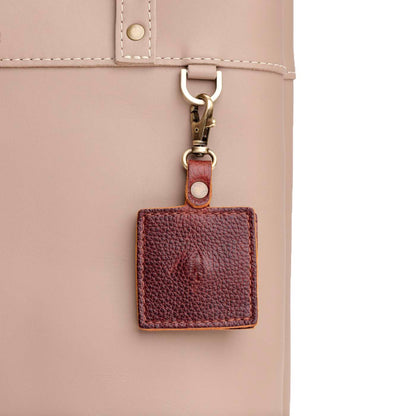 Nutmeg | Square-shaped leather AirTag holder with snap closure and swivel lobster claw clasp