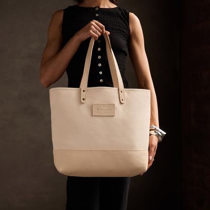 Warm Sand | Model holding canvas tote with leather base and handles