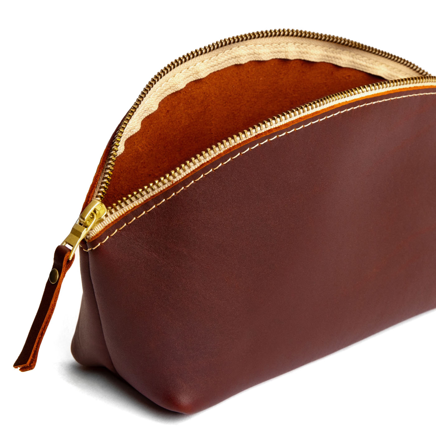 Cognac | Spacious leather makeup bag with curved seams and top zipper open