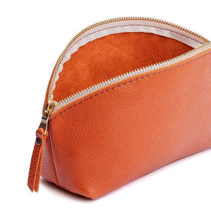 Koi | Spacious leather makeup bag with curved seams and top zipper open