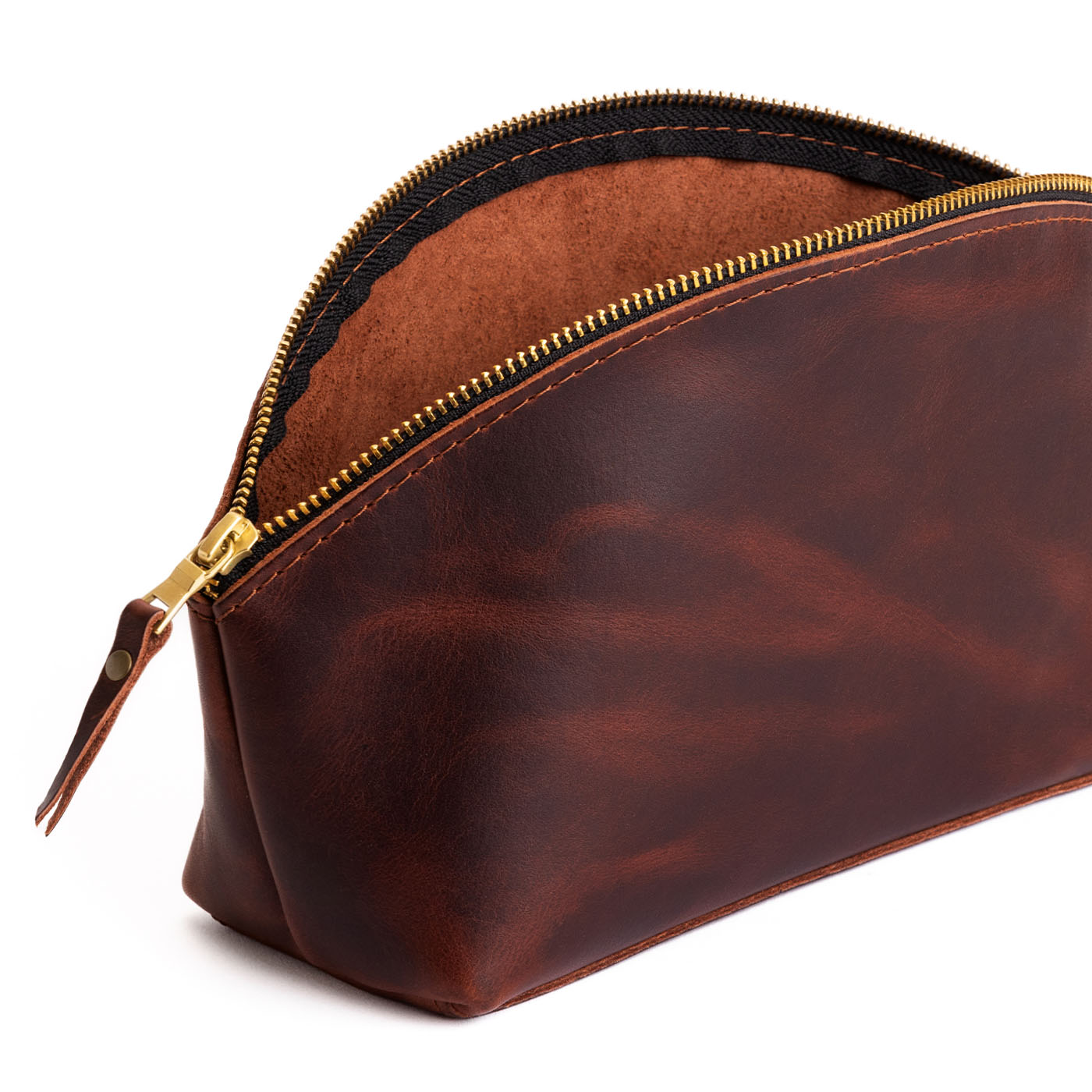 Lava | Spacious leather makeup bag with curved seams and top zipper open