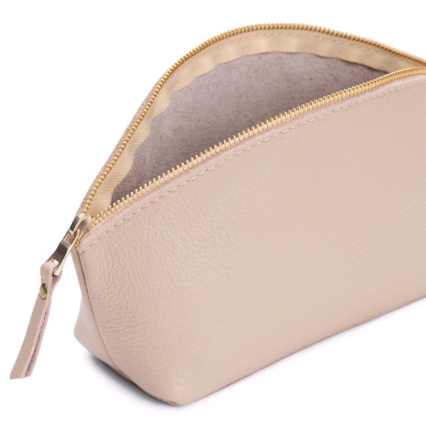Oatmilk | Close-up of spacious leather makeup bag with curved seams and top zipper