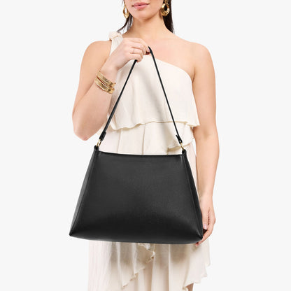 Pebbled--black*Large | Model holding large triangular shoulder bag with antiqued brass finished hardware