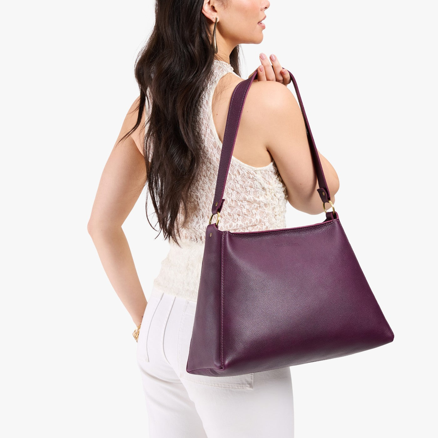 Plum*Large | Model carrying large triangular shoulder bag with antiqued brass finished hardware