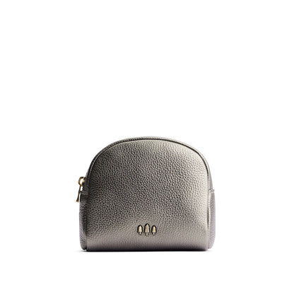 Stardust | Curved top leather pouch with zipper opening, flat base, and three metal tree emblems in front